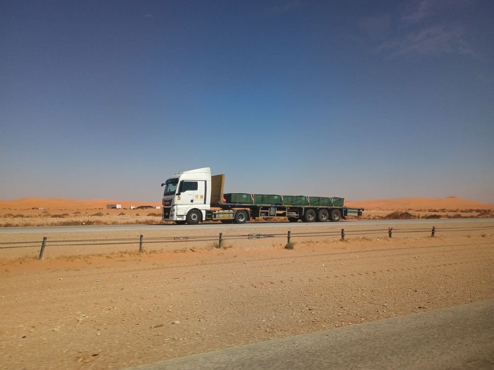 Flatbed freight truck traveling on an open highway